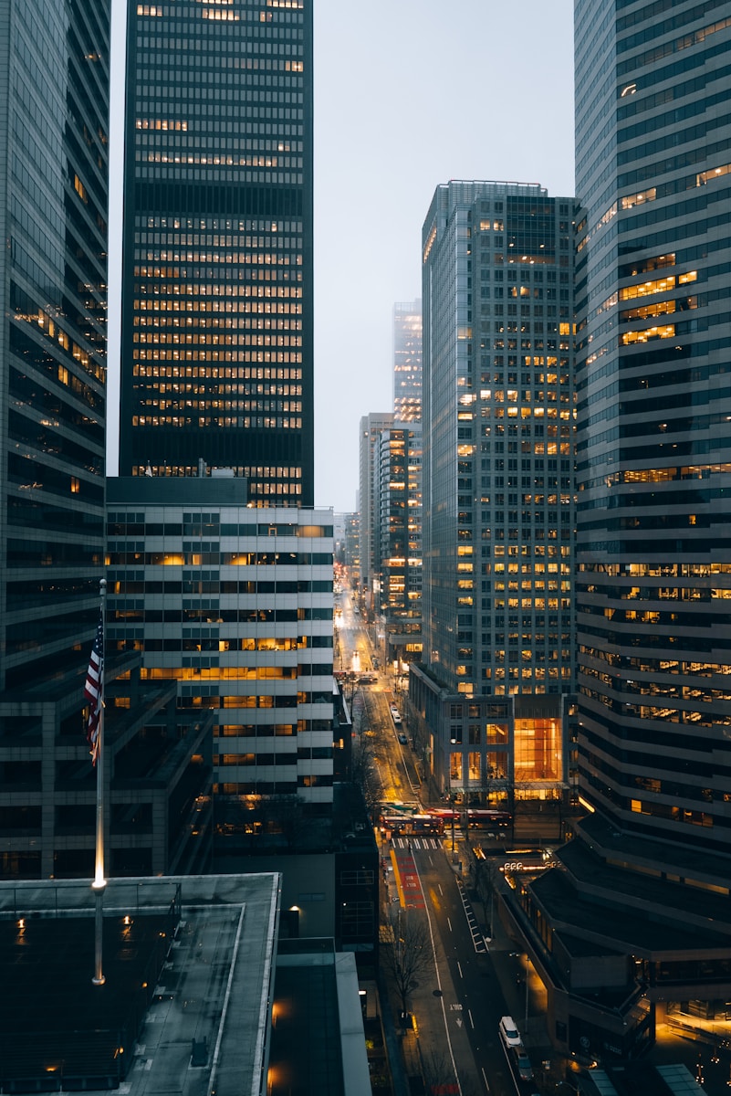 City buildings at night with lights on.